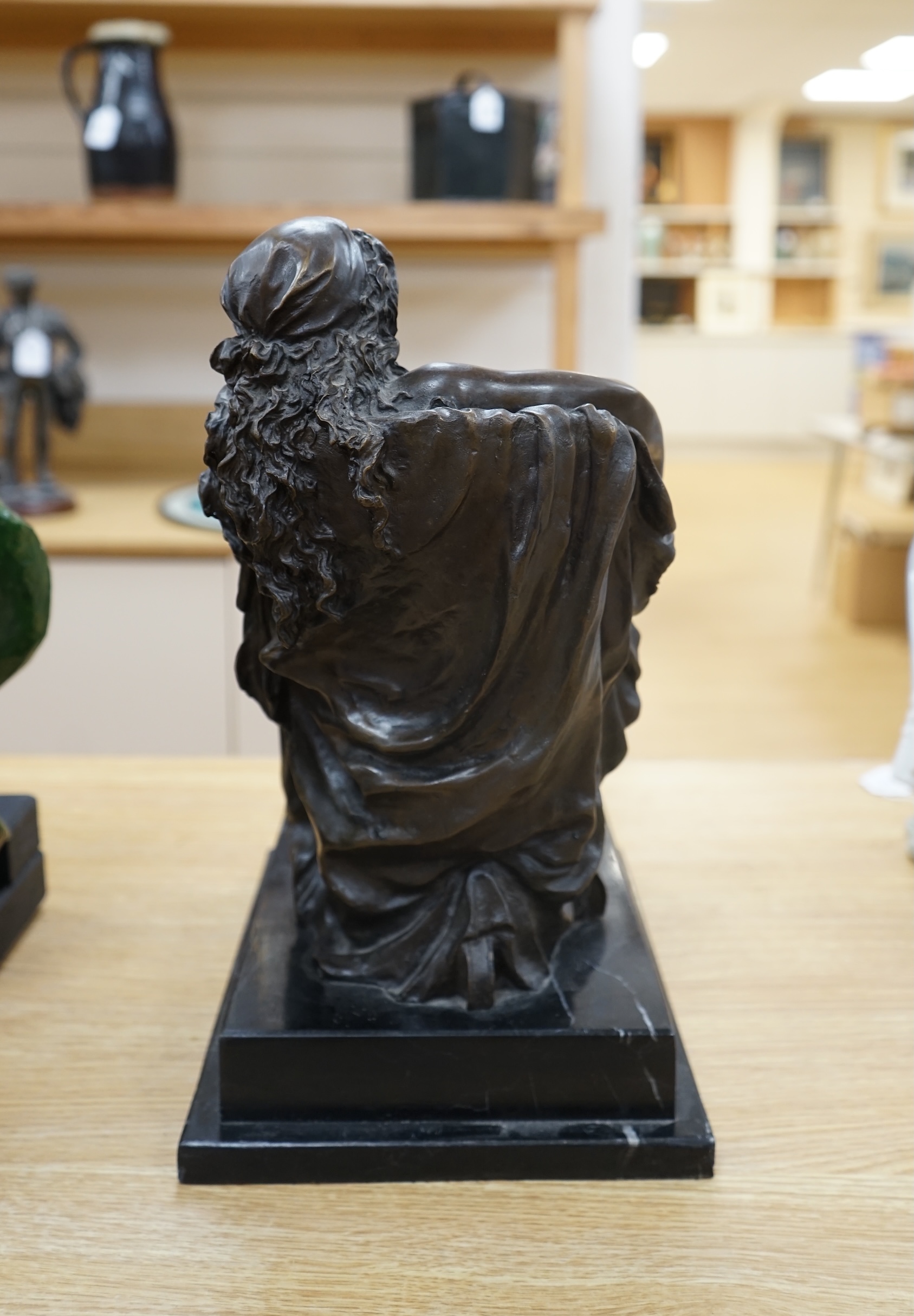 A decorative bronze study of a seated woman, raised on a stepped marble plinth, signed Chiparus, 41cm high. Condition - good